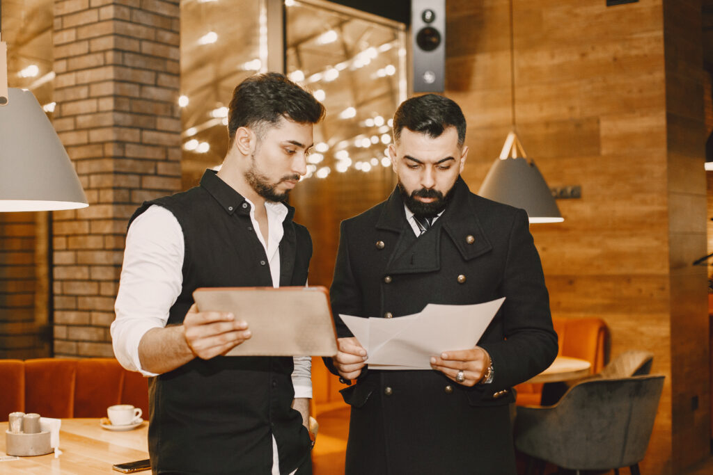 Two stylish businessmen working together